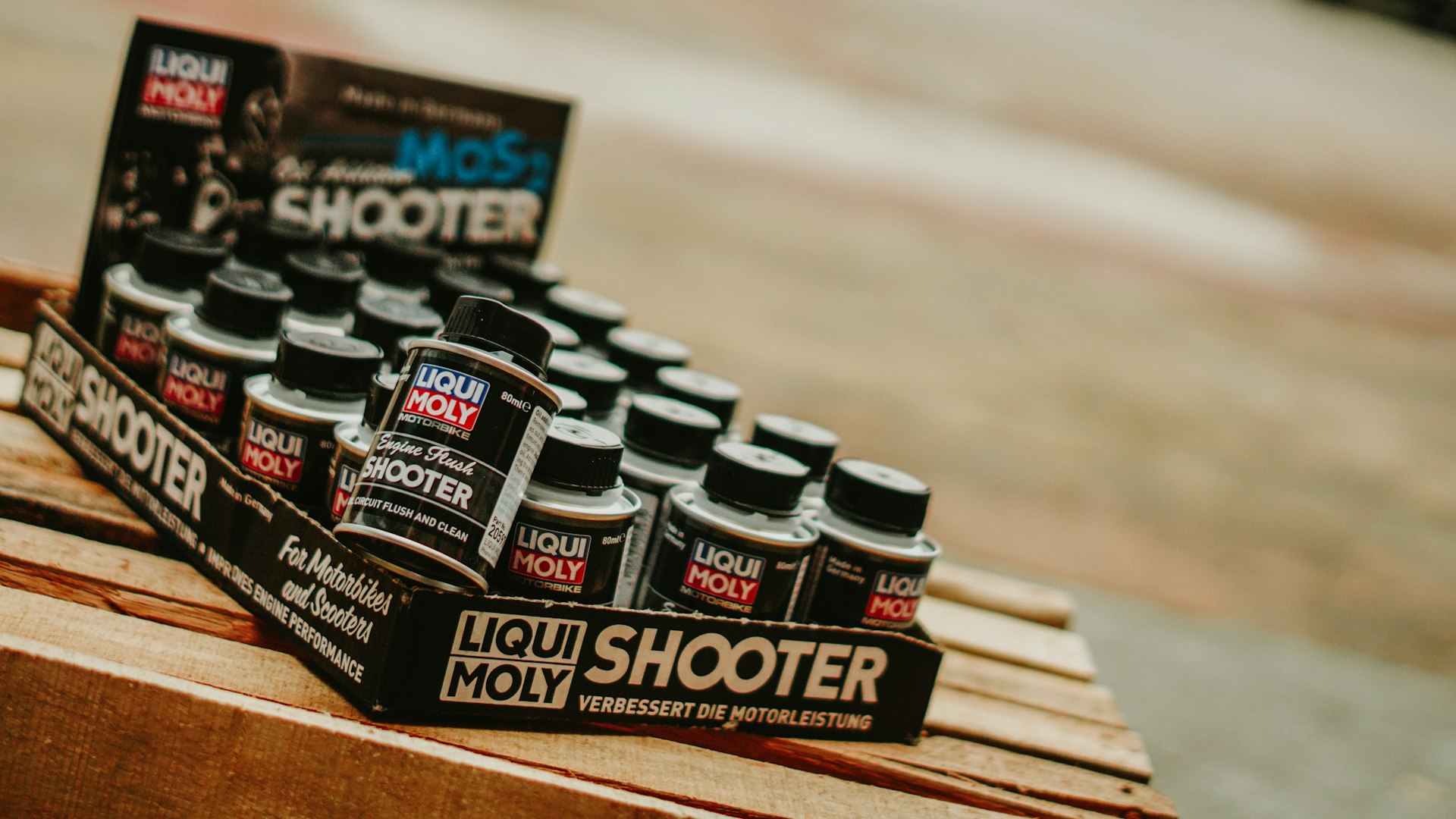 Liqui moly shooter bottles displayed on a shelf.